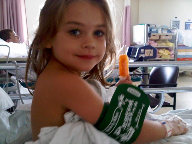 A child patient in a hospital warn with a popsicle